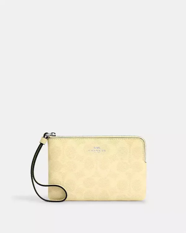COACH CORNER ZIP WRISTLET IN SIGNATURE CANVAS